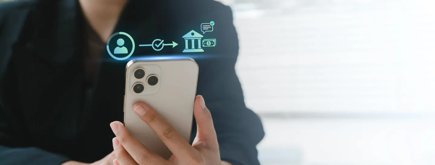 FECU member holding a smartphone with transfer transaction and notification alert icons.